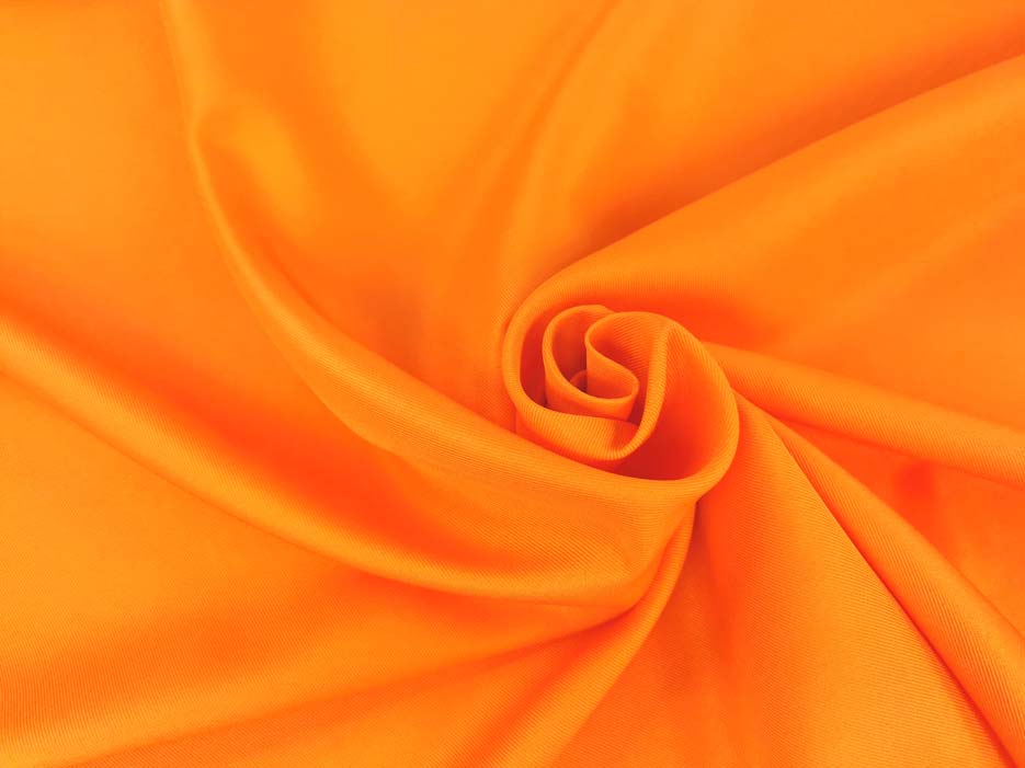 Zdjęcie przedstawiające tkaninę poliestrową Diagonal w kolorze pomarańczowym w przybliżeniu na splot materiału
