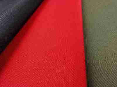 Zdjęcie prezentujące tkaninę wodoodporną Ripstop w trzech kolorach- czarnym, czerwonym oraz zieleni khaki